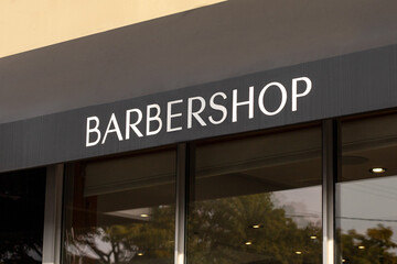 Barber shop sign on building. Hairdresser shop