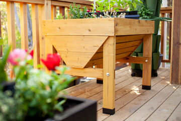 Fototapeta na wymiar A springtime view of an elevated wooden patio garden planter