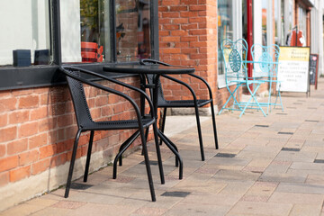 Fototapeta na wymiar Small table and two chairs outdoors. Street cafe