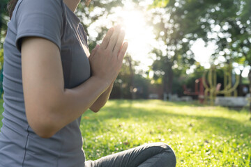 woman practicing meditate on the park. Asian woman doing exercises in morning. balance, recreation,...