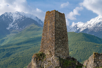 Ancient defensive Ossetian tower in a mountain landscape on a June morning. Tsmiti, Upper Fiagdon. North Ossetia Alania. Russian Federation