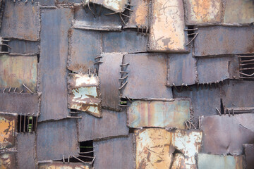 Weathered iron wall with seamless background of iron products