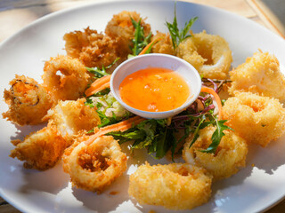 Fried Squid Served with vegetable salad and plum sauce.