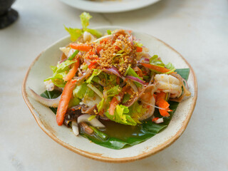 Seafood Glass Noodle Salad Famous Thai food served on a plate with vegetables.