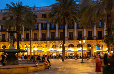 Place of attraction for tourists and citizens of Barcelona is Royal Square. Warm summer evening in...