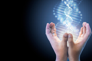 Close-up man's hand contained DNA molecules and a gleaming light rose from his hand on blue background design. Genetics of living things. Concept of medical, treatment, science, discovery, biology.
