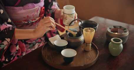 Traditional, matcha and Japanese woman with tea in home with herbs, powder and flavor in teapot....
