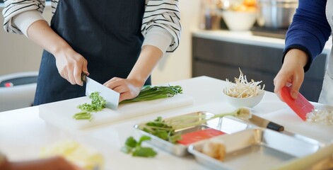 Chef hands, knife and spring onion for cooking, chopping and prepare ingredients for catering...