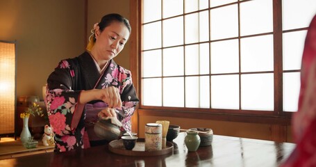 Traditional, culture and Japanese woman with tea in home with herbs, leaves and flavor in teapot. Kimono, indigenous and person with matcha beverage for ceremony, ritual and wellness for drinking