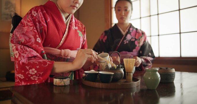 Traditional, teapot and Japanese women with tea for culture with herbs, leaves and flavor in home. Ritual, indigenous and people with herbal beverage for calm, ceremony and drinking for wellness