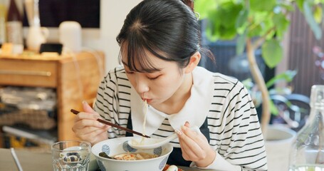 Restaurant, food and Japanese woman with noodles for eating meal, lunch and dinner in cafe. Ramen,...