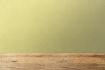 木目のあるナチュラルな木のテーブルと凹凸のある辛子色の壁の背景
