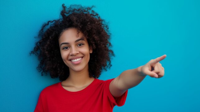 Happy Woman pointing with Finger standing against a Blue Background in the Style of Red Azure Fashion - Youthful Candid Moments Female Wallpaper created with Generative AI Technology