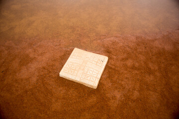 red clay baseball field and various views of the baseball home plate