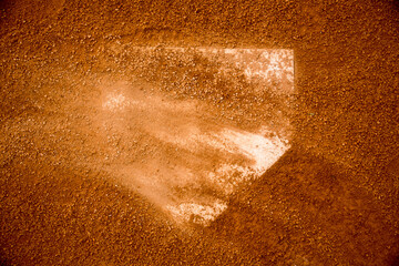 red clay baseball field and various views of the baseball home plate