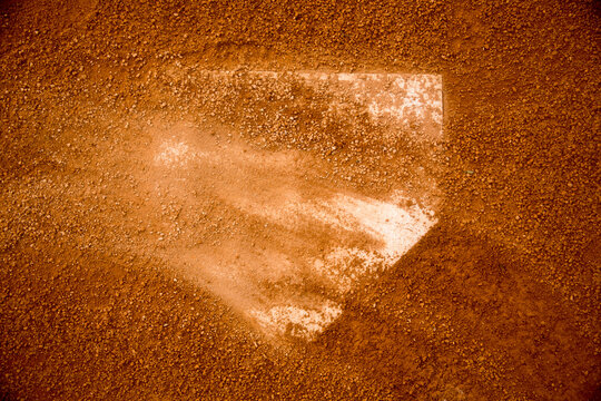 red clay baseball field and various views of the baseball home plate