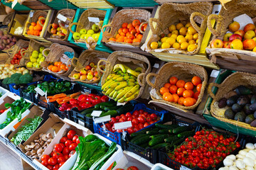 Fototapeta na wymiar Raw fresh vegetables and fruits assortment on counter in supermarket