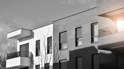 Fragment of the building's facade with windows and balconies. Modern apartment buildings on a sunny...