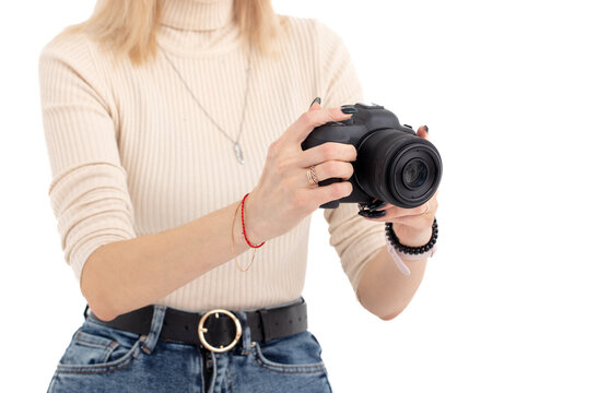 A girl with a camera takes pictures isolated on a white background