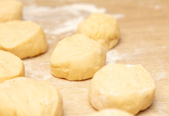 Fototapeta na wymiar Pieces of dough on the table in flour.