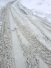 Traces from car wheels on white snow