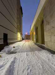 The walls of the building are illuminated at night in winter