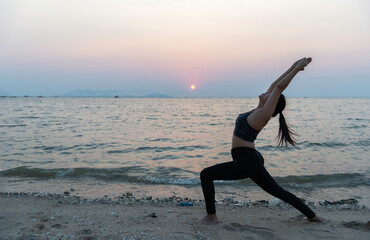 Young woman practicing yoga during luxury yoga retreat in Asia, meditation, relaxation, exercise