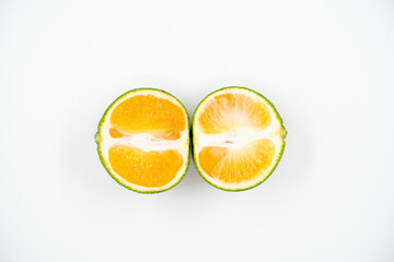 Cut green tangerine close up on white background isolated.