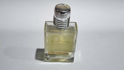 perfume bottle on a white background with a shadow on the glass