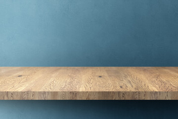 木目のあるナチュラルな木の棚(台)と青の凹凸のある壁の背景