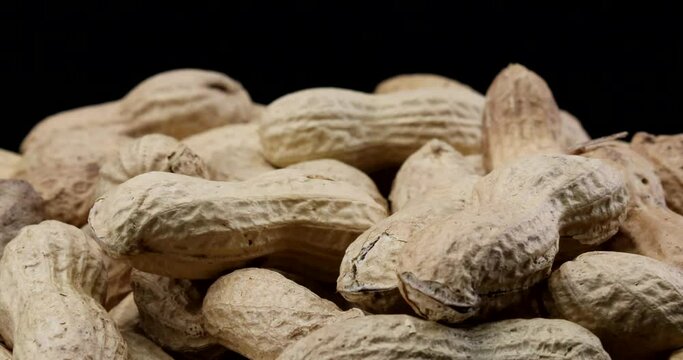 Extreme close up video of peanuts with shell in rotating motion