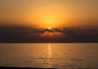 Sunrise over the Mediterranean Sea seen from the beach in Torremolinos. Costa del Sol, Spain