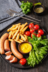 sausages with potato, lettuce, tomatoes, top view