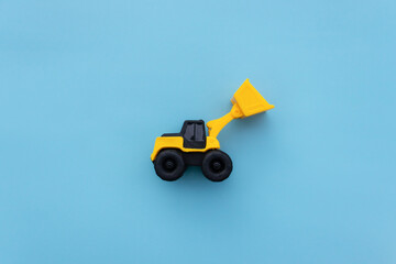 Wheel loader miniature isolated on blue background. After some edits.