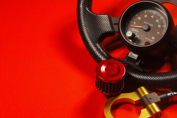 Sport car tuning equipment and spare parts on red top view background with copy space. Motorsport...