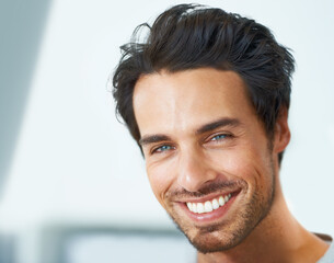 Obraz premium Smile, portrait and happy man at home with positive attitude, energy or mindset. Joy, face or handsome male person in a house with good mood, confidence or chilling on day off, weekend or vacation