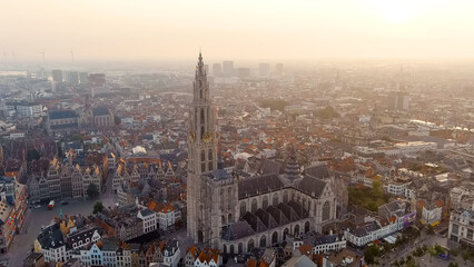 Fototapeta na wymiar Antwerp, Belgium - July 21, 2023: Spire with the clock of the Cathedral of Our Lady (Antwerp). City Antwerp is located on river Scheldt (Escaut). Summer morning, Aerial View