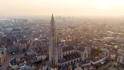 Foto op Plexiglas Antwerp, Belgium - July 21, 2023: Spire with the clock of the Cathedral of Our Lady (Antwerp). City Antwerp is located on river Scheldt (Escaut). Summer morning, Aerial View © nikitamaykov