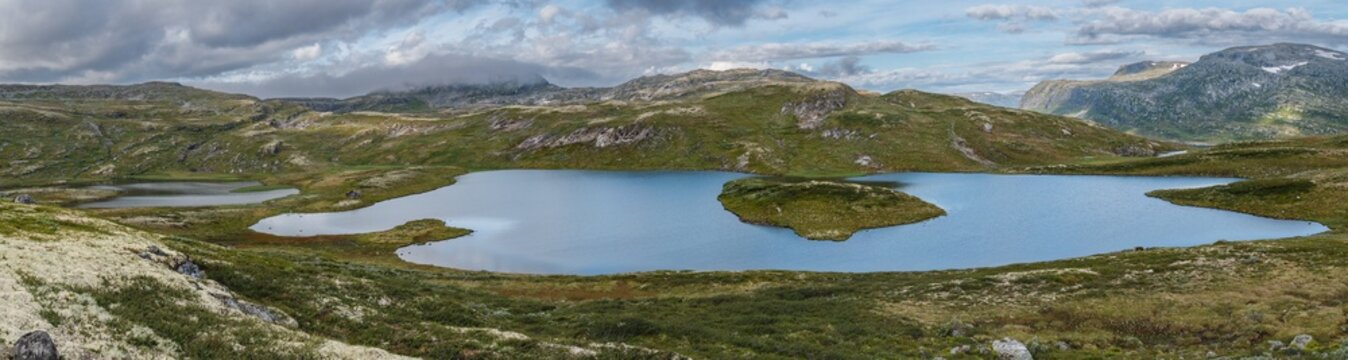 Barren fjell landscape in panorama format with lakes and mountains in the vicinity of Tyin, Norway
