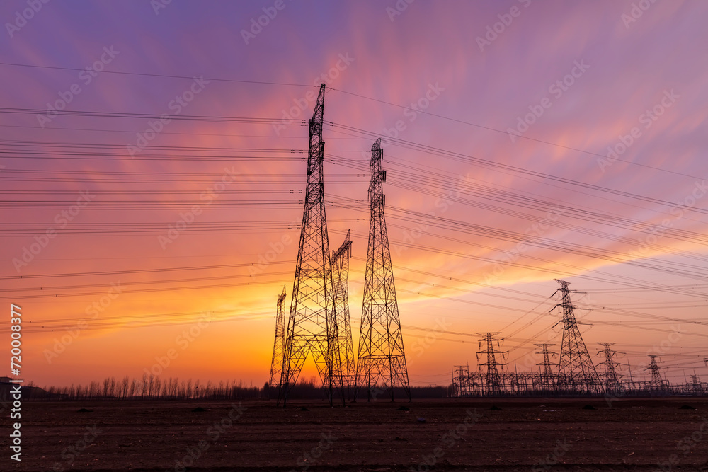 Wall mural the pylons are in the evening, substation in the evening, high voltage substation and beautiful suns