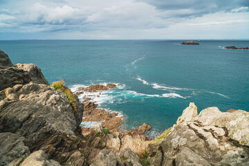 Ocean waves caress rugged rocks.