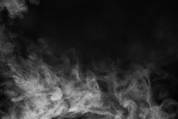 Blur white water vapour on isolated black background. Abstract of steam with copy space.  Smoke on black background. Steam flow.