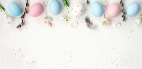 Easter eggs with different colors and patterns on light abstract background with space for text