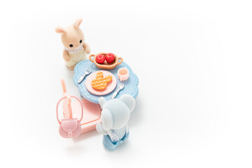 Miniature dollhouse furniture isolated on white background. Animal doll. Kids toy. Play and learn. Kids room. Childhood. Kindergarten toy. Developmental toys. Tiny dining table. Cute doll.