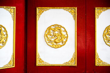 The wooden cabinets on the wall along with various Chinese-style decorations.
