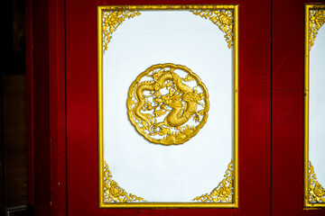 The wooden cabinets on the wall along with various Chinese-style decorations