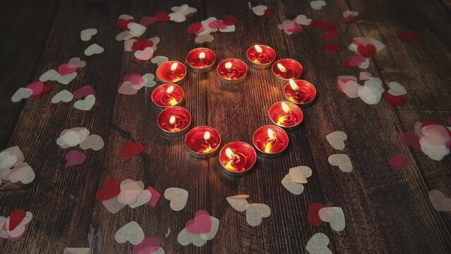 Red candles tea lights in wooden background. Celebration decoration for Christmas, romantic Valentine's Day. Decorative and relaxation symbol