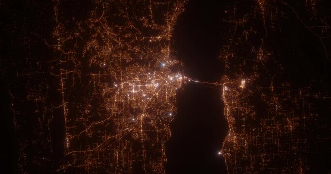 Mobile (Alabama, USA) aerial view at night. View on modern city from space. Camera is zooming in, rotating counterclockwise