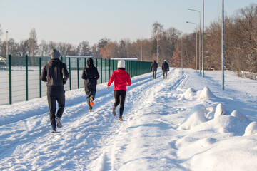 People walk in a winter park.