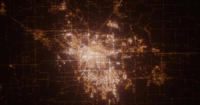 Springfield (Illinois, USA) top view at night. Aerial view on modern city from space. Camera is flying above the city, moving forward. Vertical video. The north is on the left side